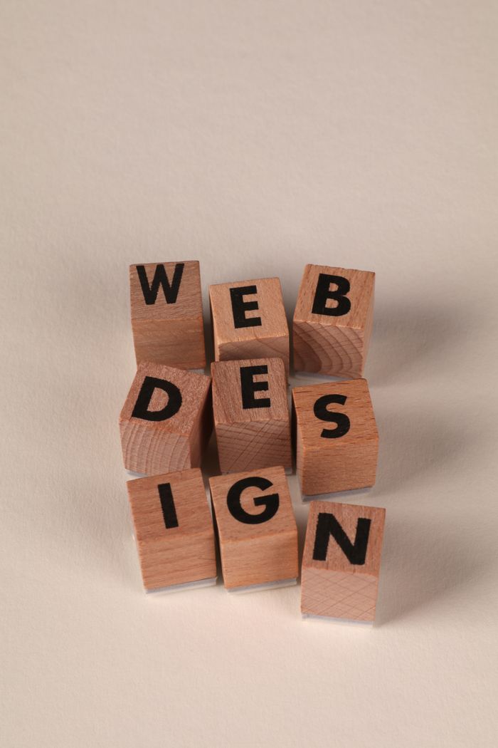 our-experience Wooden blocks arranged to spell 'Web Design'. Perfect for creative, digital content themes.