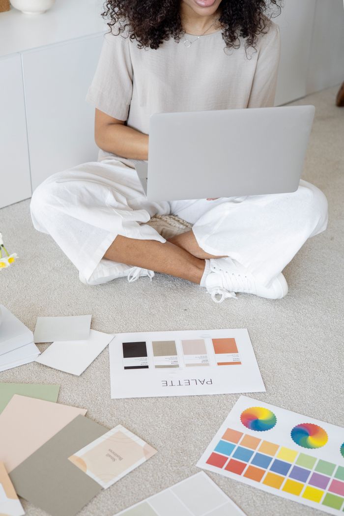 The Art of Drawing Readers In: Your attractive post title goes here Young woman reviews color palettes for design project on laptop, sitting indoors.